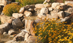 Waterfall With Stream Crossing : This beautifully designed feature also acts as a delivery system to the pool.